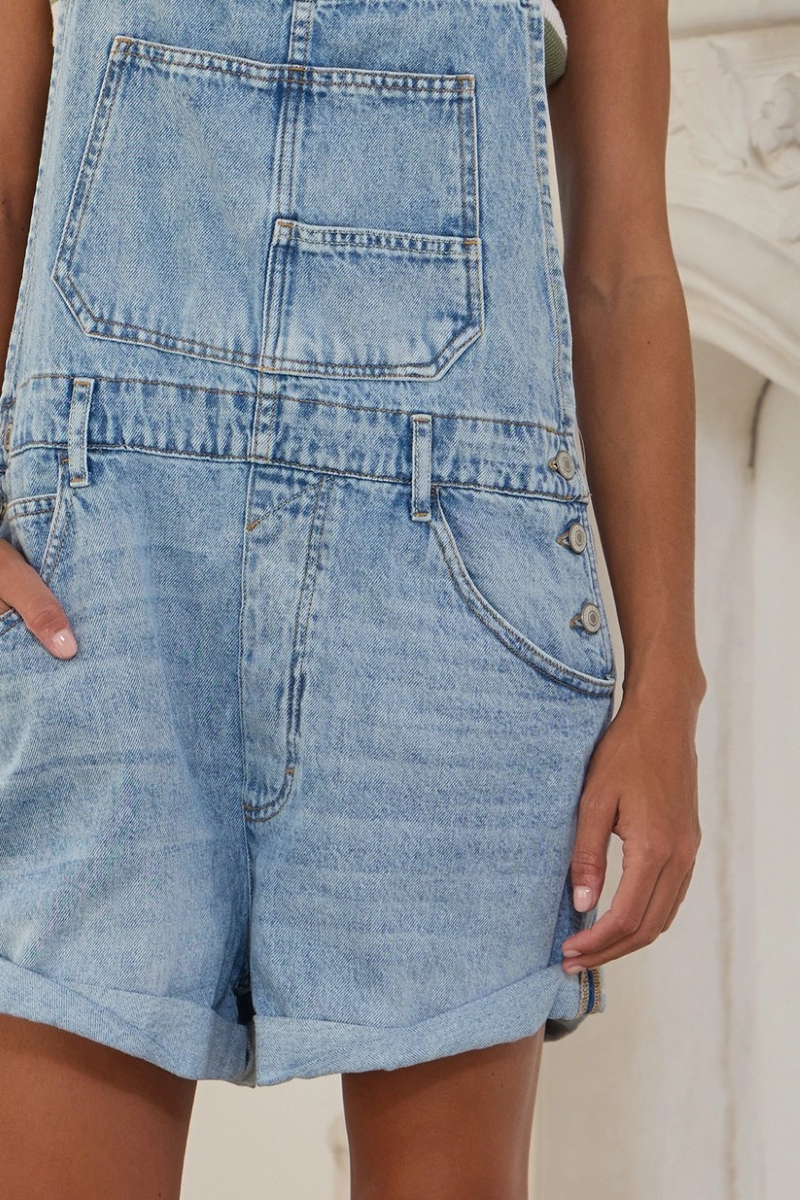 Close up of front pocket denim bib overall shorts